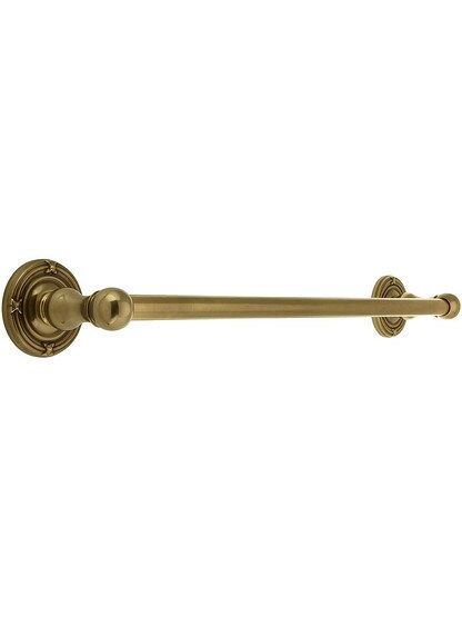 18 inch Brass Towel Bar with Ribbon and Reed Rosettes in Antique Brass.